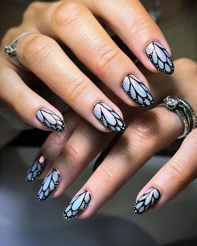 Lilac-blue ombré almond nails painted as butterfly wings with black outlines