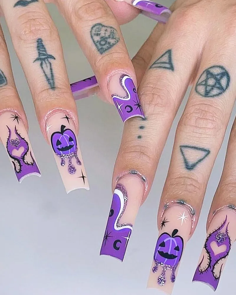 Purple drip French coffin nails with hand-painted pumpkins, potion bottles and stars for Halloween