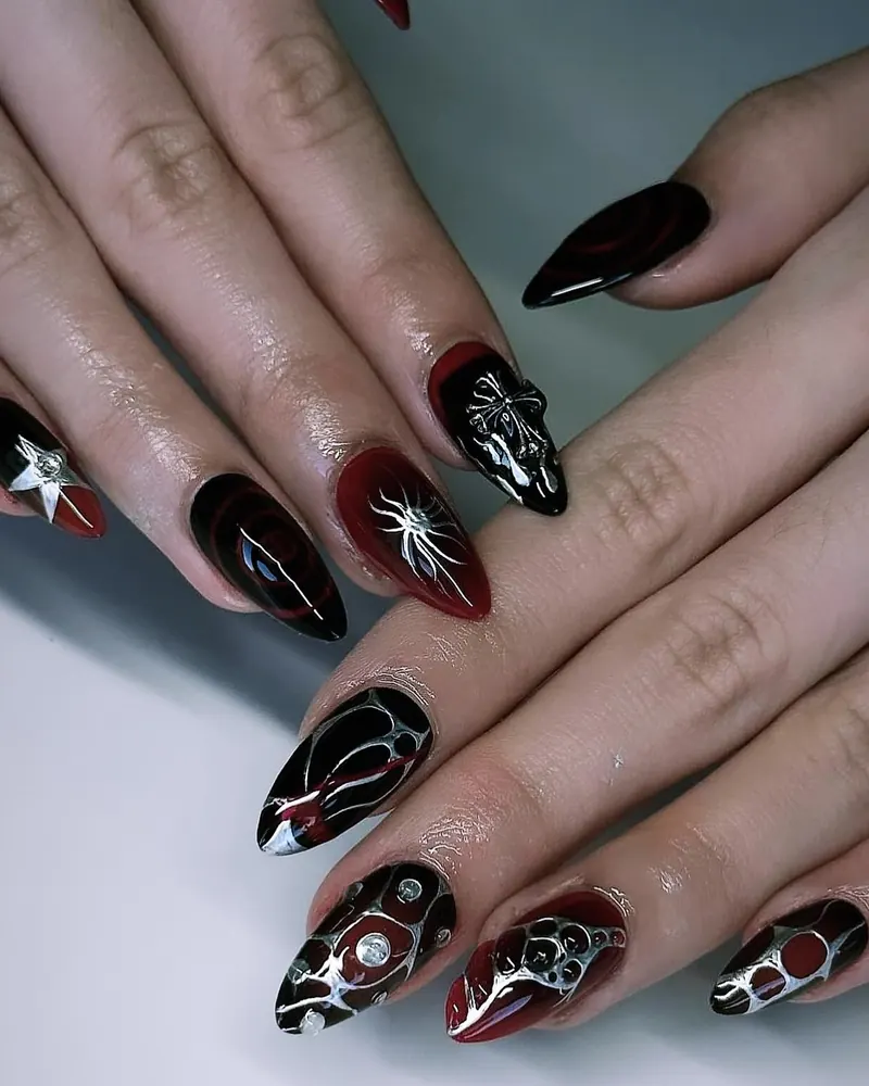 Black and red almond nails with spiders, webs and chrome studs