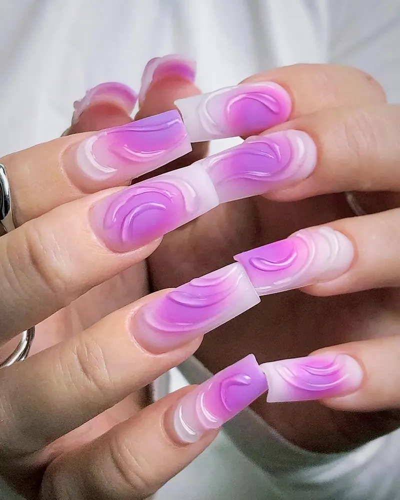 Square nails with a milky base and magenta airbrush aura swirls