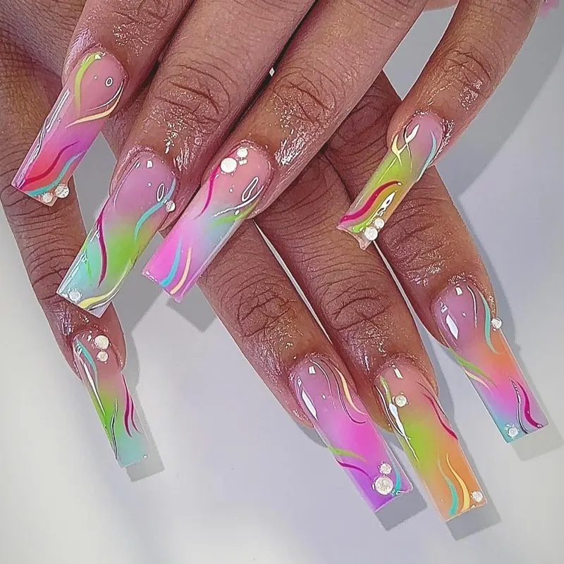 Long coffin nails with rainbow airbrush, hand-painted swirls and gold dots