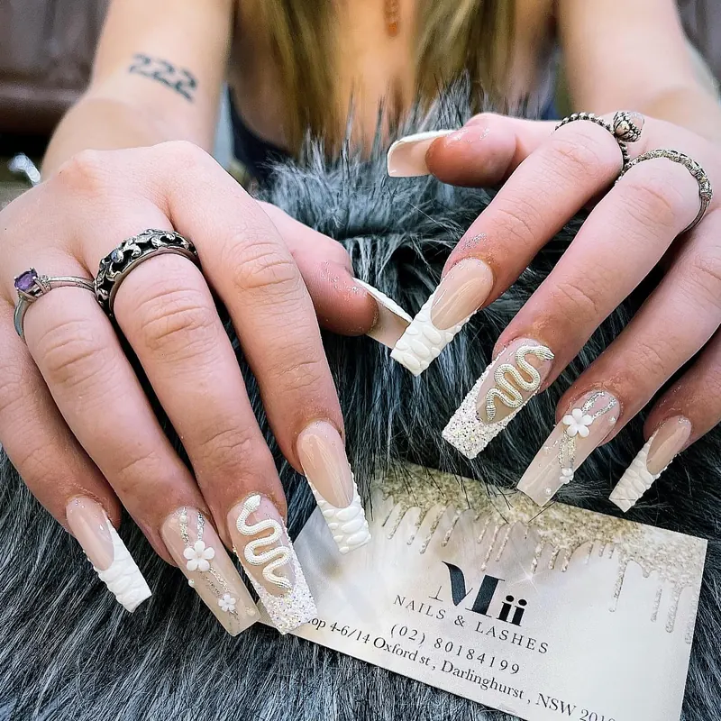 Nude coffin nails with white French, sculpted 3D swirls, flowers and glitter