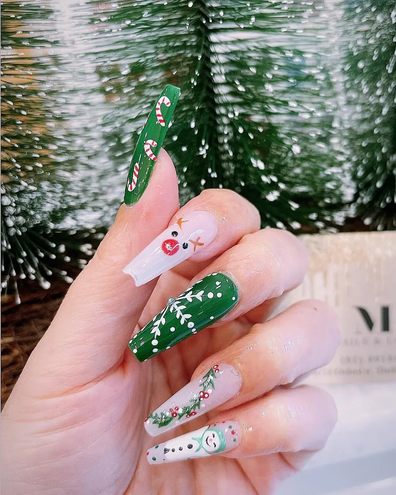 Green and milky coffin nails with candy canes, holly, a snowman and crystals